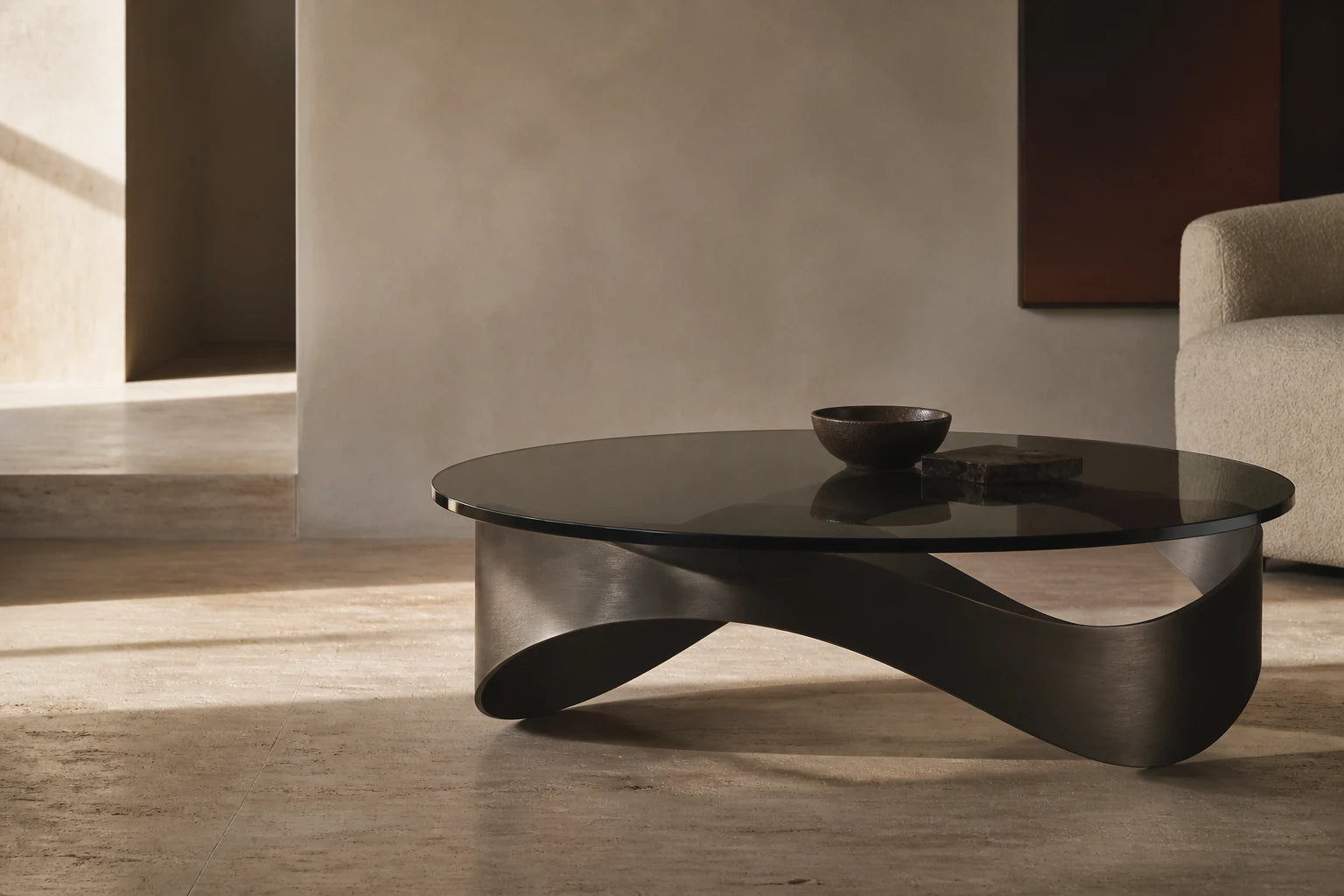 A sculptural glass table in a calm, sunlit interior